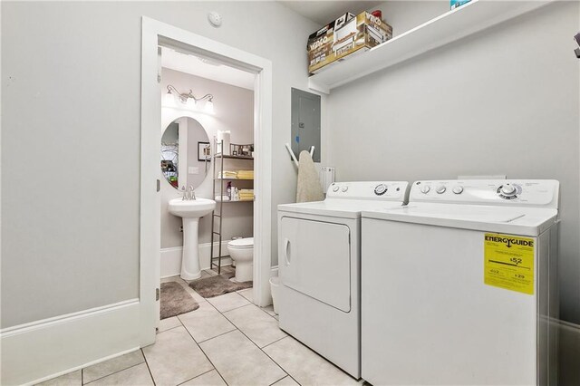 727 N Salcedo St, New Orleans, LA 70119 - clothes washing area featuring separate washer and dryer, baseboards, light tile patterned floors, laundry area, and a sink
