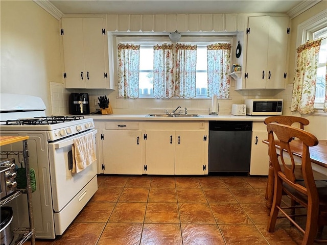 kitchen with white appliances, light countertops, decorative backsplash, a sink, and dark tile patterned flooring