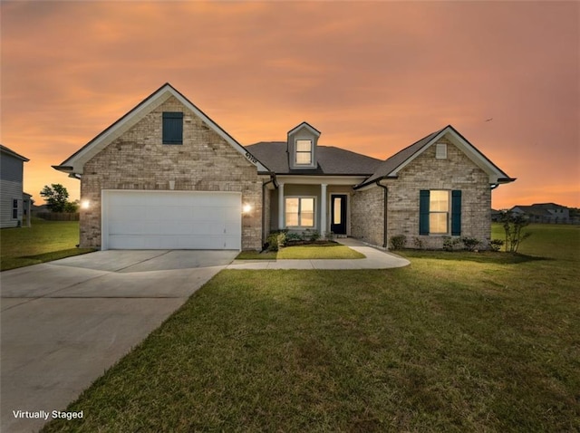 9508 E Terran Ln, Waggaman, LA 70094 - traditional-style house featuring a yard, driveway, a garage, and brick siding