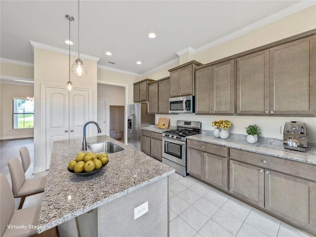 9508 E Terran Ln, Waggaman, LA 70094 - kitchen with appliances with stainless steel finishes, a breakfast bar, crown molding, light stone counters, and pendant lighting