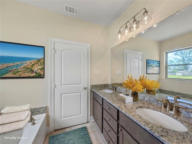 9508 E Terran Ln, Waggaman, LA 70094 - bathroom featuring double vanity, a garden tub, and tile patterned floors