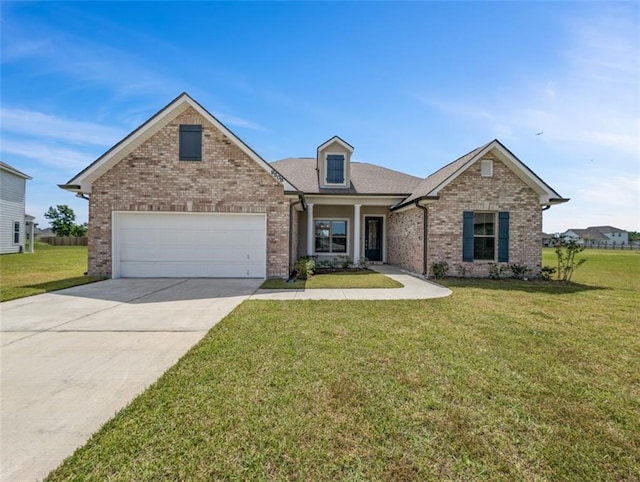 9508 E Terran Ln, Waggaman, LA 70094 - view of front of house with brick siding, concrete driveway, a front lawn, and a garage