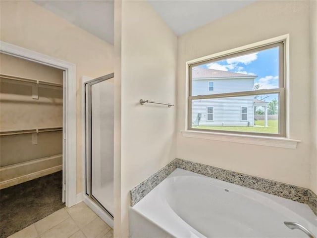 9508 E Terran Ln, Waggaman, LA 70094 - bathroom with a bath, a shower stall, a walk in closet, and tile patterned floors