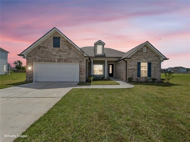 9508 E Terran Ln, Waggaman, LA 70094 - view of front of property with concrete driveway, a front lawn, a garage, and brick siding