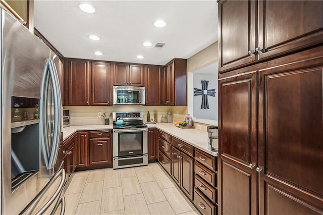 123 Fischer Dr, Pearl River, LA 70452 - kitchen featuring recessed lighting, appliances with stainless steel finishes, visible vents, and light countertops