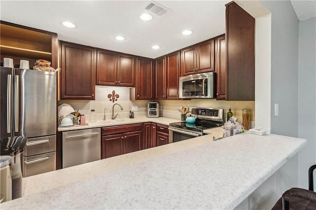 123 Fischer Dr, Pearl River, LA 70452 - kitchen with a sink, stainless steel appliances, light countertops, visible vents, and recessed lighting