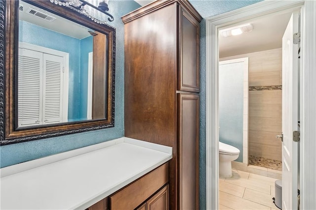 123 Fischer Dr, Pearl River, LA 70452 - full bathroom featuring tile patterned floors, a stall shower, toilet, visible vents, and vanity
