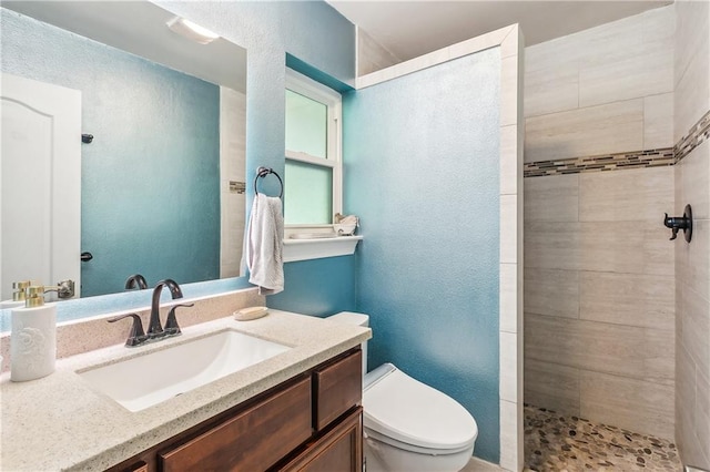 123 Fischer Dr, Pearl River, LA 70452 - full bath with toilet, a textured wall, vanity, and tiled shower