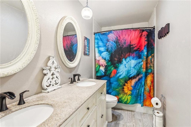 123 Fischer Dr, Pearl River, LA 70452 - full bathroom with a shower with shower curtain, wood finished floors, toilet, and a sink