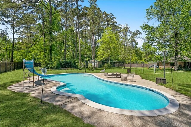 123 Fischer Dr, Pearl River, LA 70452 - view of pool featuring a fenced in pool, a water slide, fence, a patio area, and a yard