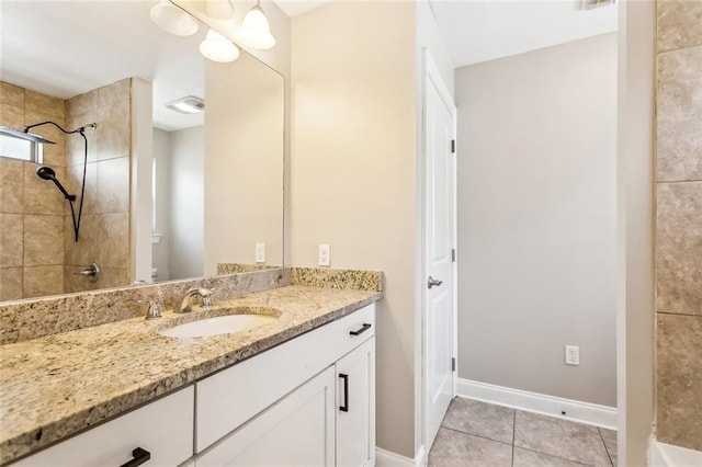 bathroom featuring baseboards, vanity, and tile patterned flooring