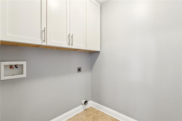 clothes washing area featuring cabinet space, hookup for a washing machine, baseboards, and electric dryer hookup