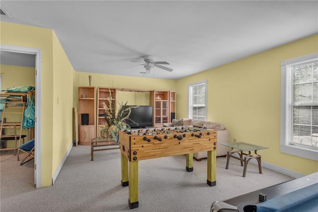 rec room with carpet floors, a ceiling fan, and a wealth of natural light