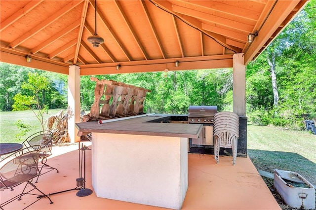 view of patio featuring area for grilling, a gazebo, and exterior kitchen