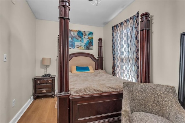 bedroom featuring light wood-style flooring and baseboards