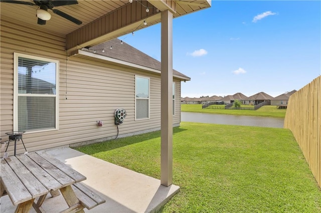 42403 Tigers Eye Stone Ave, Prairieville, LA 70769 - view of yard with a patio area, a water view, a ceiling fan, fence, and a residential view