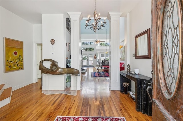 2820 Desoto St, New Orleans, LA 70119 - foyer entrance featuring ornate columns, wood finished floors, a ceiling fan, and a chandelier