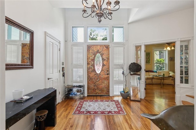 2820 Desoto St, New Orleans, LA 70119 - foyer featuring a chandelier, a high ceiling, and wood finished floors