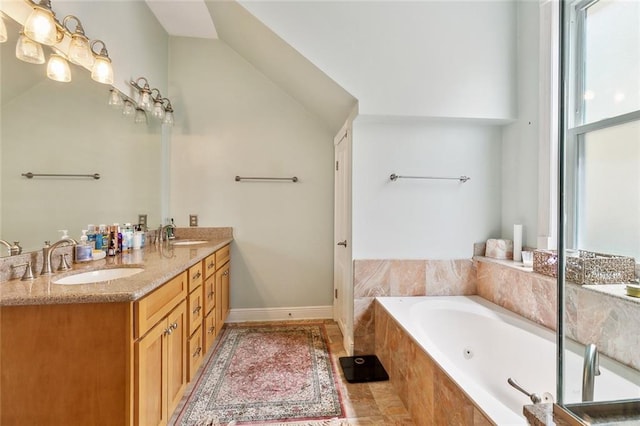 2820 Desoto St, New Orleans, LA 70119 - bathroom featuring double vanity, a jetted tub, and lofted ceiling