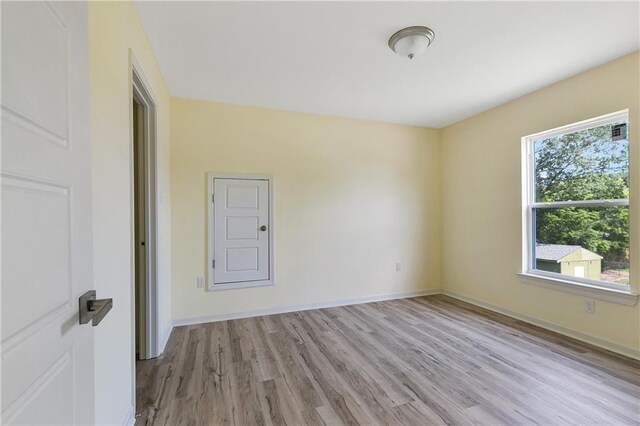 4536 Laine Ave, New Orleans, LA 70126 - empty room featuring plenty of natural light, light wood-style flooring, and baseboards