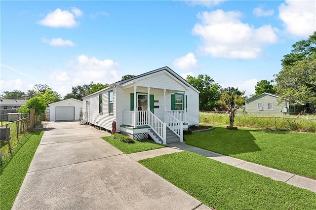 1929 Kentucky Ave, Kenner, LA 70062 - view of front of property with fence, concrete driveway, an outdoor structure, a detached garage, and a porch