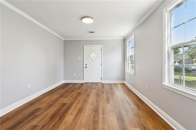 1929 Kentucky Ave, Kenner, LA 70062 - entrance foyer with wood finished floors, visible vents, baseboards, and ornamental molding