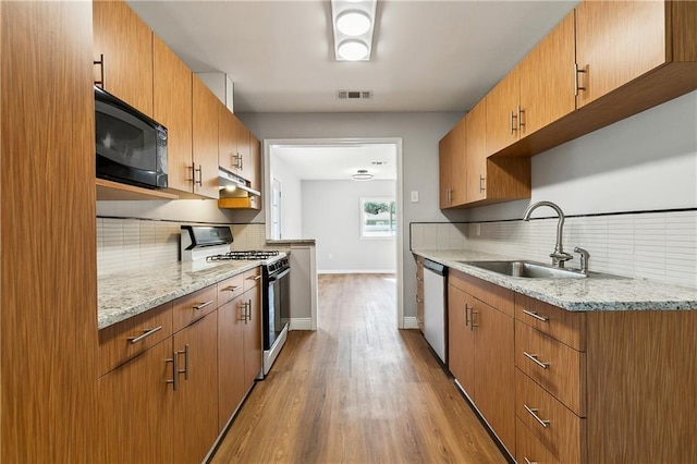 1929 Kentucky Ave, Kenner, LA 70062 - kitchen with stainless steel dishwasher, range with gas stovetop, a sink, black microwave, and visible vents