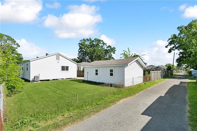 1929 Kentucky Ave, Kenner, LA 70062 - view of home's exterior with cooling unit, a lawn, and fence