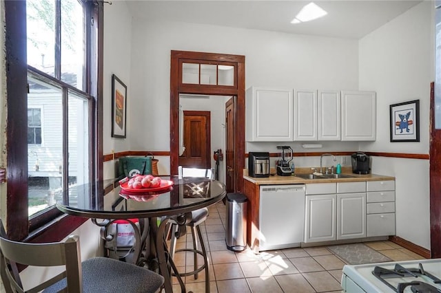 3725 Orleans Ave, New Orleans, LA 70119 - kitchen with white cabinets, a sink, white appliances, and plenty of natural light