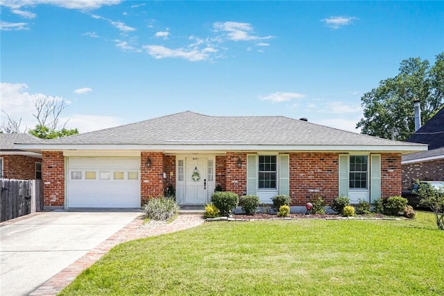 ranch-style home featuring concrete driveway, fence, brick siding, an attached garage, and a front yard