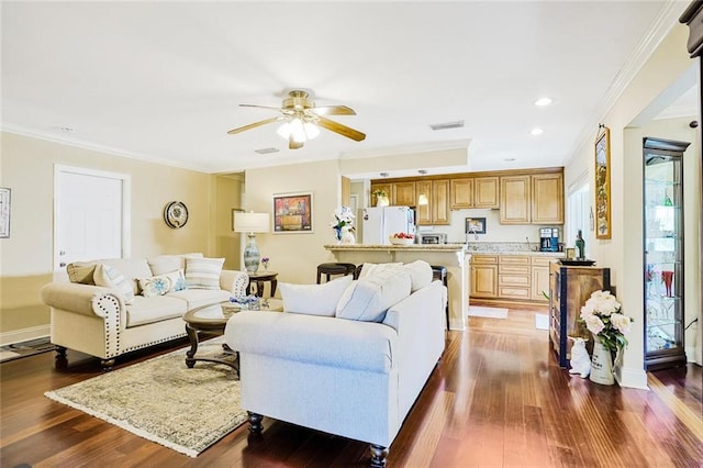 living area featuring ceiling fan, ornamental molding, and dark wood finished floors
