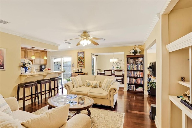 9621 Charlotte Dr, River Ridge, LA 70123 - living room with crown molding, dark wood finished floors, a ceiling fan, and a chandelier
