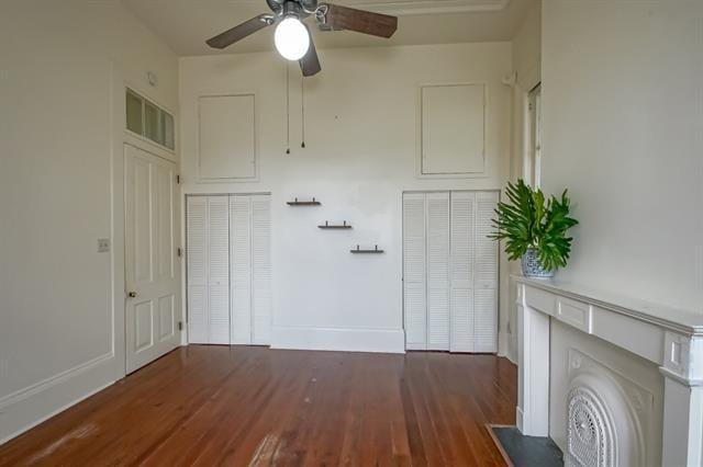 interior space with wood finished floors, baseboards, and ceiling fan