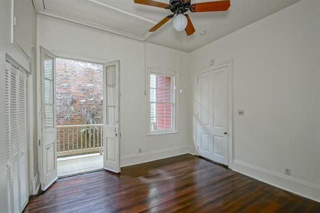 entryway with ceiling fan, baseboards, and wood finished floors