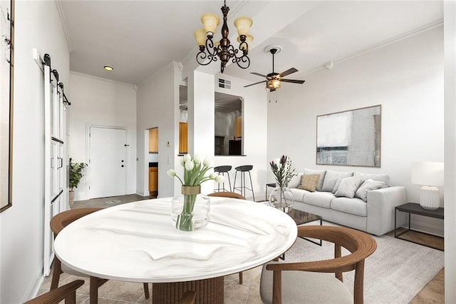 dining room with a barn door, crown molding, visible vents, and ceiling fan with notable chandelier