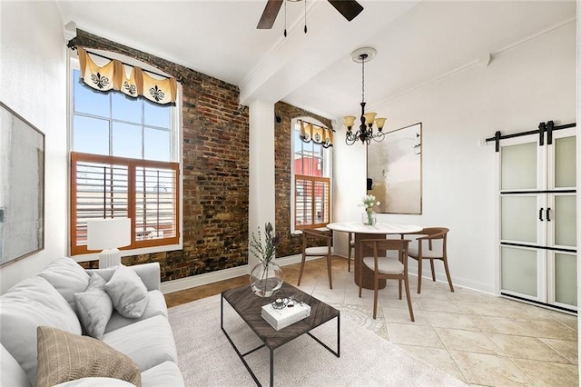 living area with a wealth of natural light, baseboards, and ceiling fan with notable chandelier