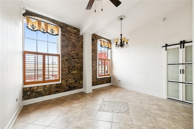 unfurnished dining area featuring ceiling fan with notable chandelier, baseboards, a wealth of natural light, and a barn door