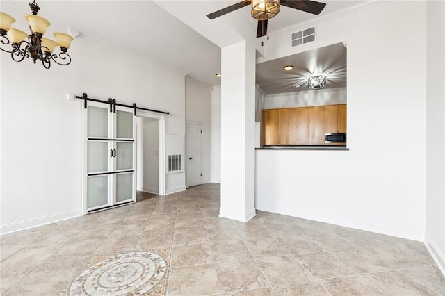 unfurnished living room with a barn door, crown molding, visible vents, and ceiling fan with notable chandelier