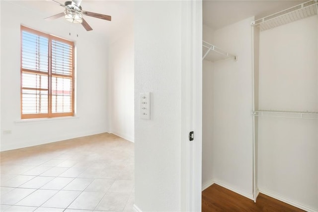 walk in closet with a ceiling fan