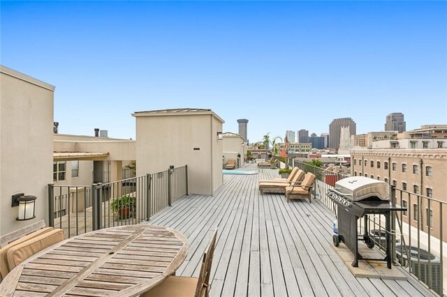 wooden terrace with a view of city and area for grilling