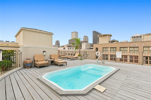 view of swimming pool with a wooden deck