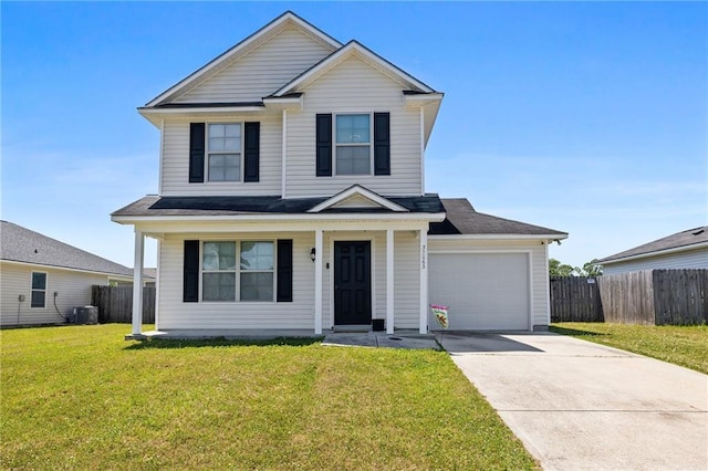 traditional-style home featuring central AC, concrete driveway, a front lawn, fence, and a garage