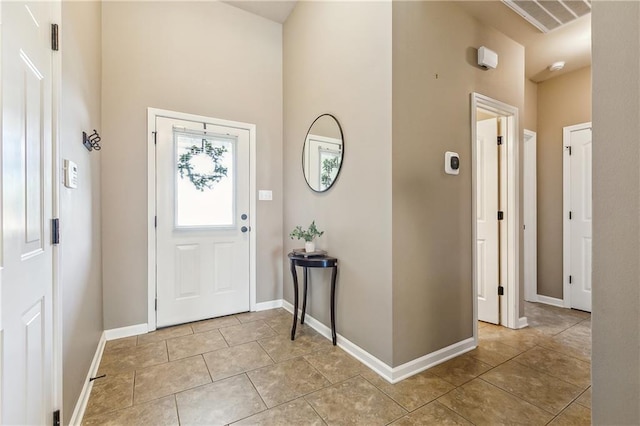 39521 Rue Royale, Prairieville, LA 70769 - entrance foyer featuring visible vents, baseboards, a high ceiling, and light tile patterned floors