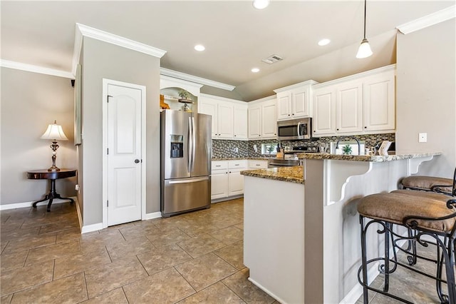 39521 Rue Royale, Prairieville, LA 70769 - kitchen featuring crown molding, tasteful backsplash, stainless steel appliances, and visible vents