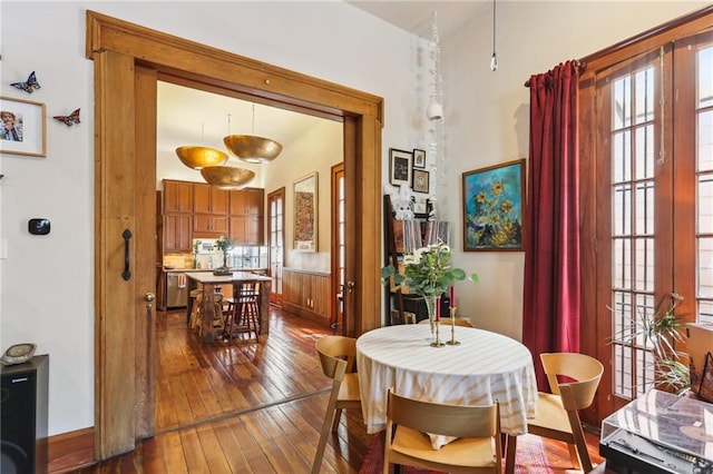 925 Touro St, New Orleans, LA 70116 - dining area with baseboards, a healthy amount of sunlight, and dark wood-style floors