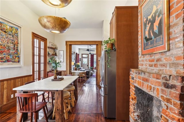 925 Touro St, New Orleans, LA 70116 - hallway with dark wood-type flooring, a wainscoted wall, wood walls, and french doors