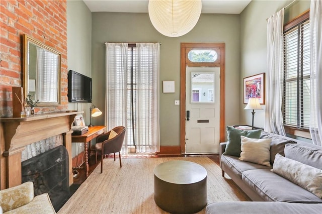 925 Touro St, New Orleans, LA 70116 - living area featuring baseboards, wood finished floors, and a fireplace