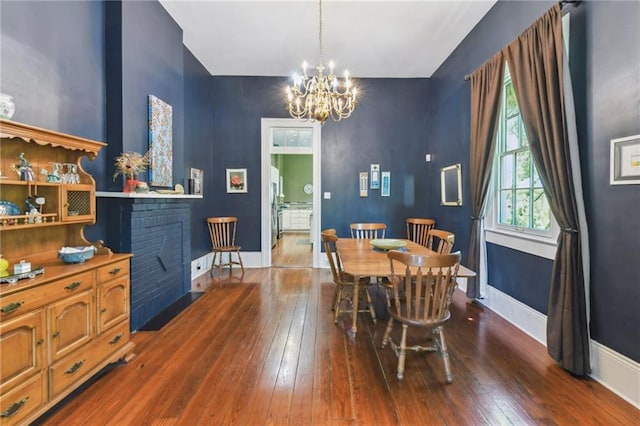 618 Belleville St, New Orleans, LA 70114 - dining area featuring hardwood / wood-style floors, baseboards, and an inviting chandelier