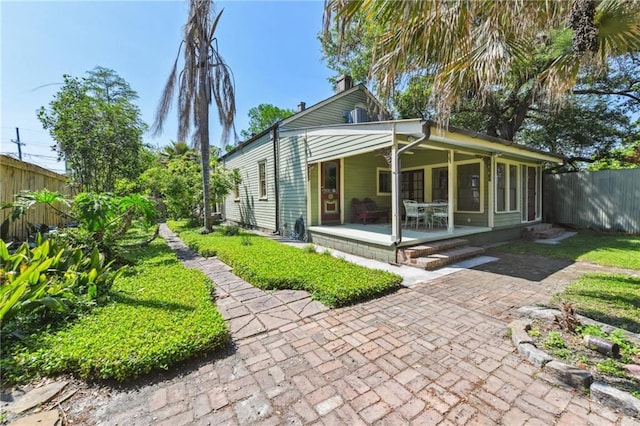 618 Belleville St, New Orleans, LA 70114 - rear view of property with fence and a patio