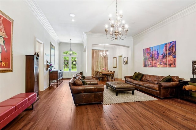 living room with arched walkways, recessed lighting, a notable chandelier, ornamental molding, and wood-type flooring
